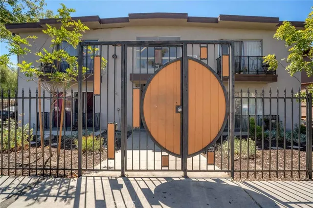 a view of a house with a tree in front of it