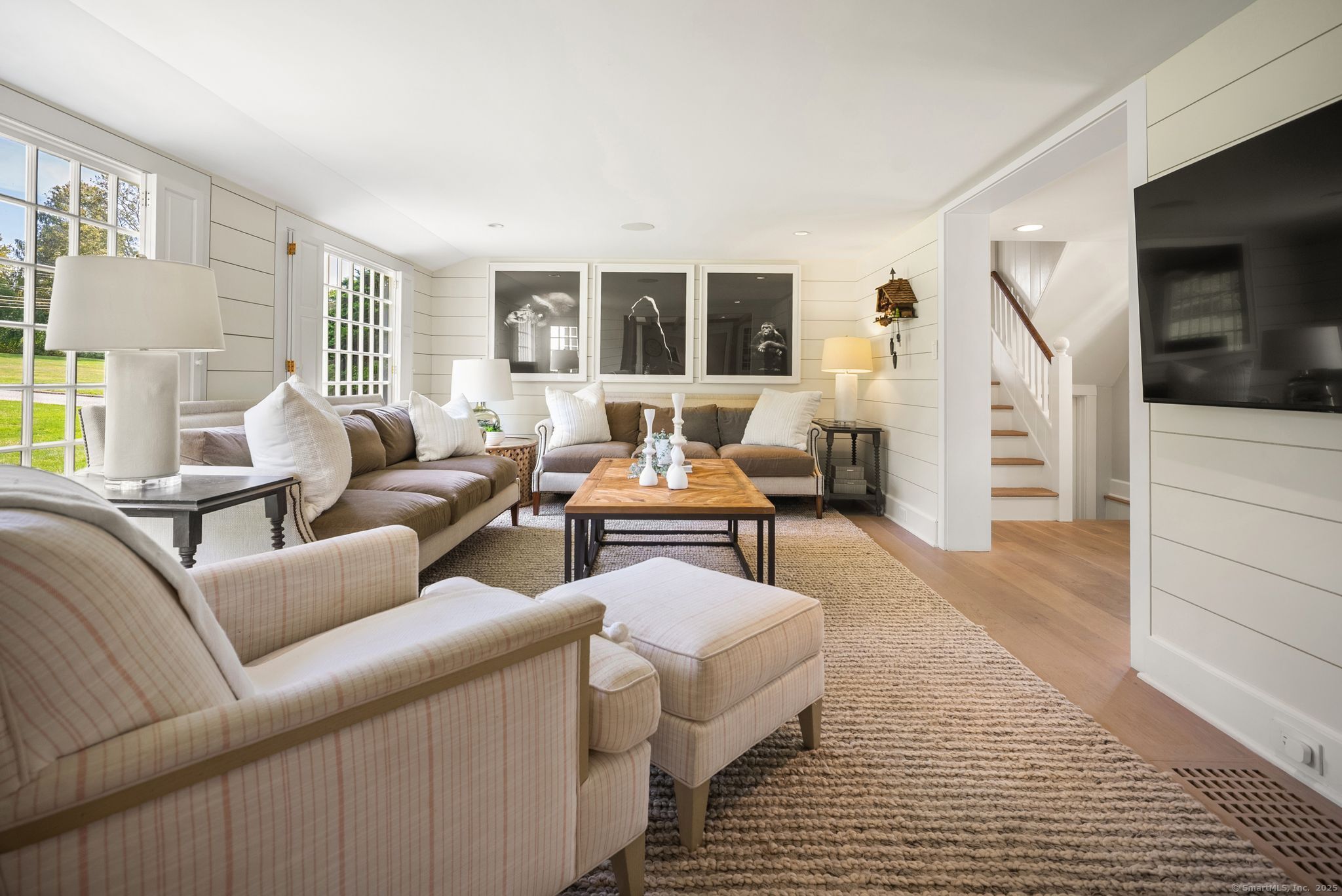 2281 Redding Road Fairfield, CT 06824 - Photo 11 of 40 a living room with furniture and a flat screen tv