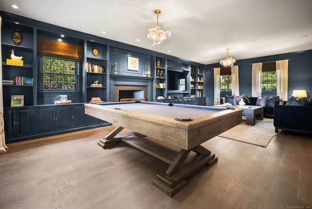 a living room with pool table and a flat screen tv