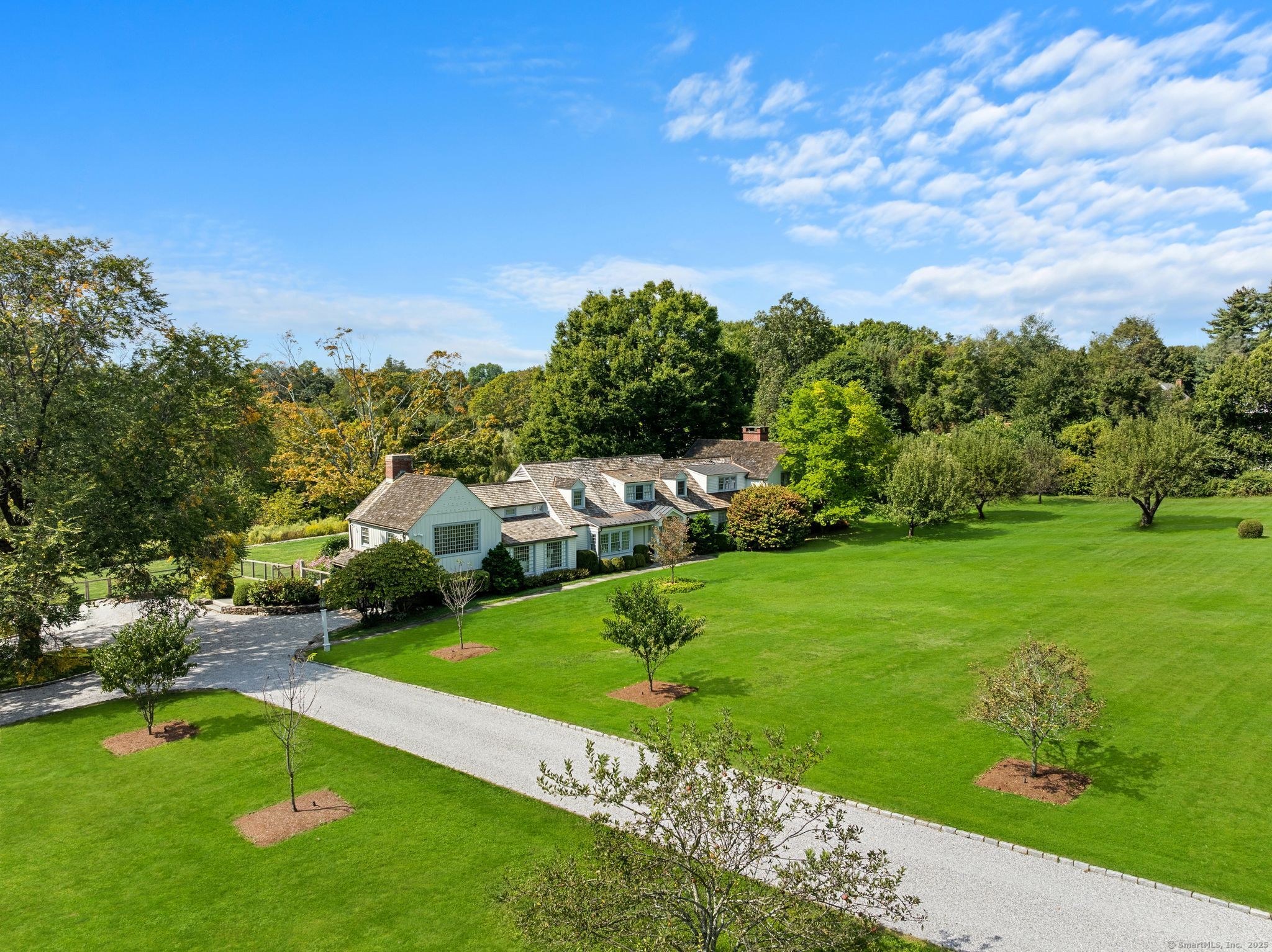 2281 Redding Road Fairfield, CT 06824 - Photo 2 of 40 a view of a big yard with potted plants and large trees