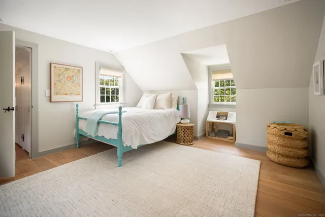 a spacious bedroom with a bed and a couch