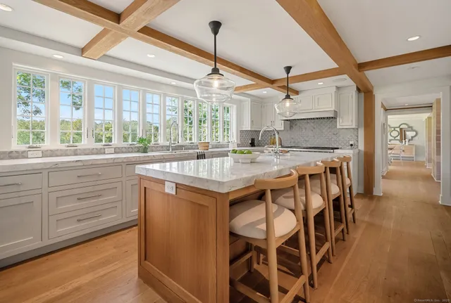 a kitchen with a stove a sink and cabinets