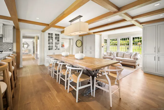 a dining room with furniture and wooden floor