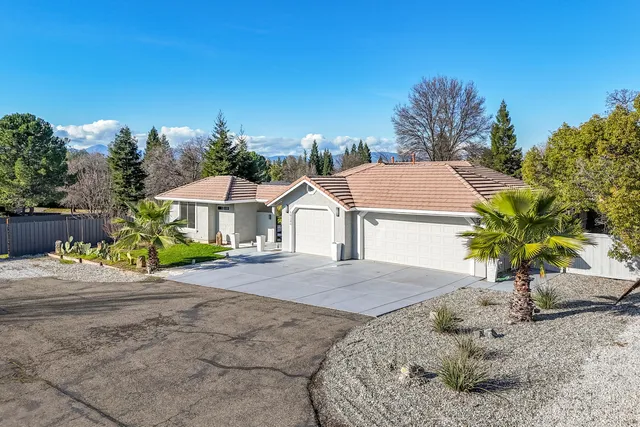 a view of a house with backyard sitting area and tub