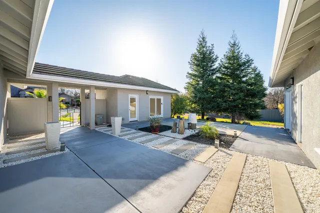 a kitchen with stainless steel appliances granite countertop a stove a sink dishwasher and a refrigerator with wooden floor