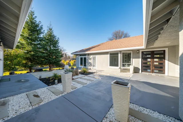 a kitchen with stainless steel appliances granite countertop a refrigerator a stove and a wooden floors
