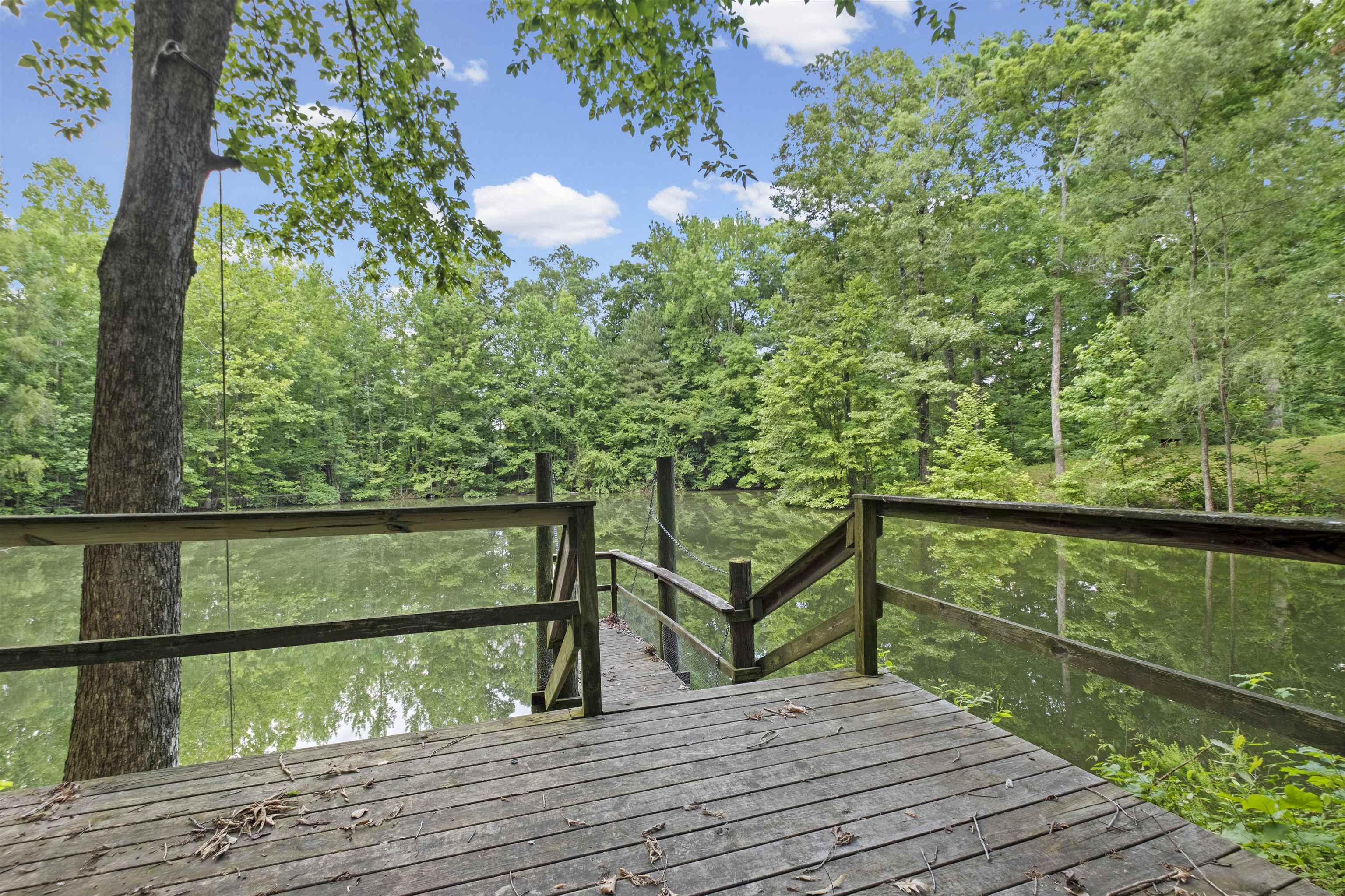 3601 Marshall Road Munford, TN 38058 - Photo 5 of 35 Wood-finish dock with a railing, overlooking a body of water surrounded by lush trees