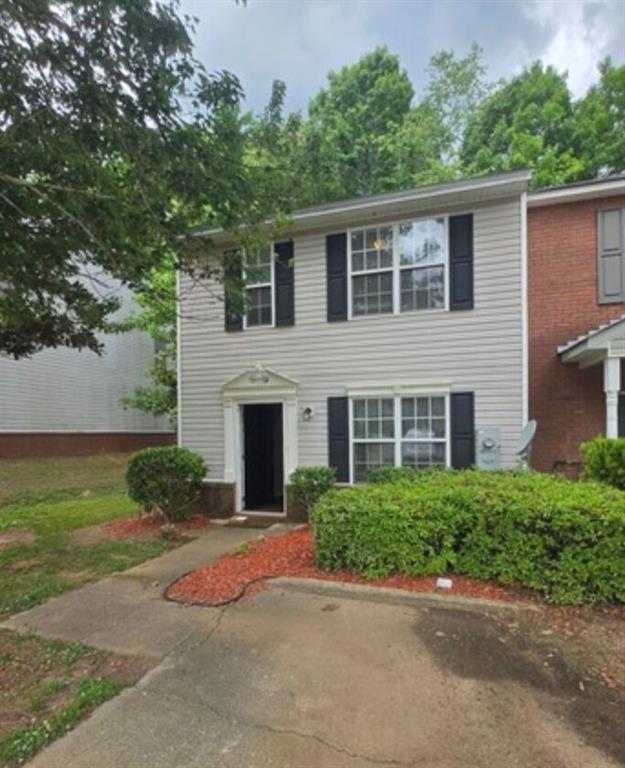 2881 Norfair Loop Lithonia, GA 30038 - Photo 1 of 5 a front view of a house with a yard and garage