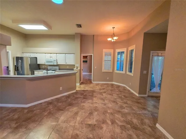 a view of a tennis ground with large trees