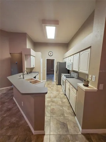 a view of a patio with a table chairs and a yard