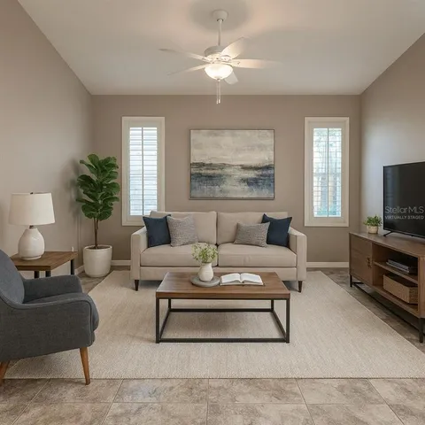 a living room with furniture a rug and a window