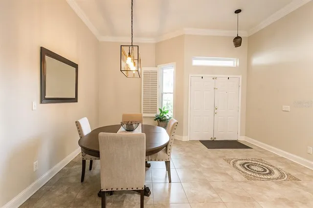 a view of a dining room with furniture and chandelier