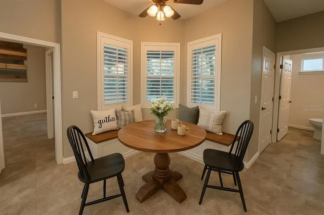 a dining room with furniture and a chandelier