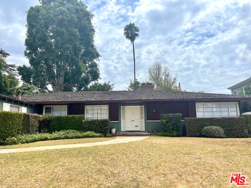 101 Larkin Place Santa Monica, CA 90402 - Photo 2 of 13 a front view of a house with a yard and garage