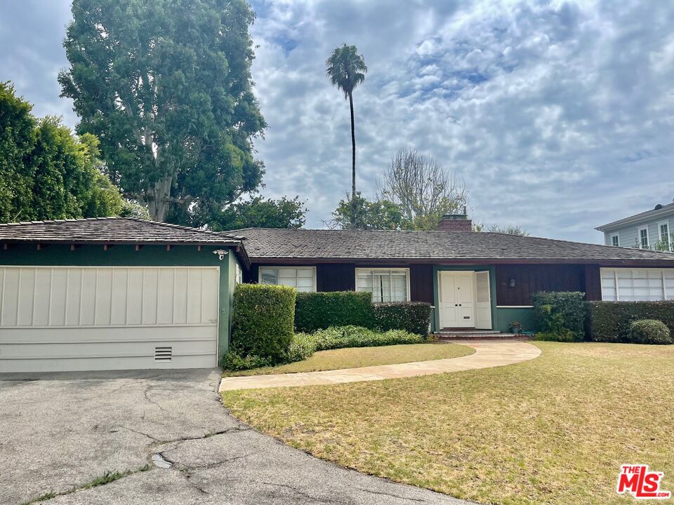 101 Larkin Place Santa Monica, CA 90402 - Photo 3 of 13 a front view of a house with a yard and garage