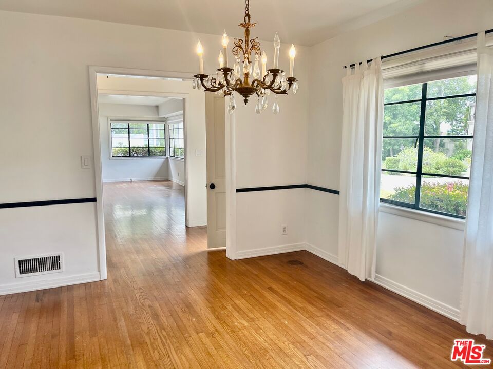 101 Larkin Place Santa Monica, CA 90402 - Photo 9 of 13 a view of a livingroom with wooden floor and a chandelier