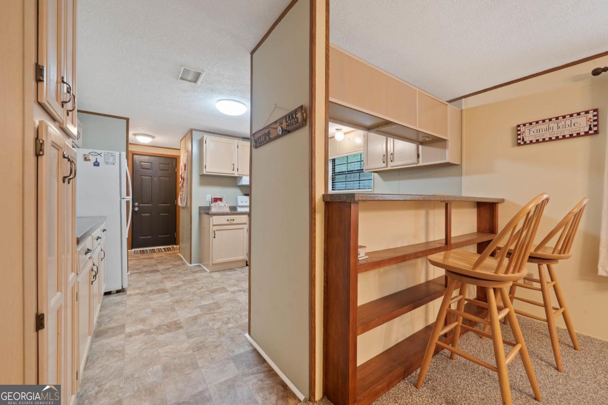 180 De Jarnette Road Southeast Eatonton, GA 31024 - Photo 13 of 66 a view of a kitchen with furniture and a window