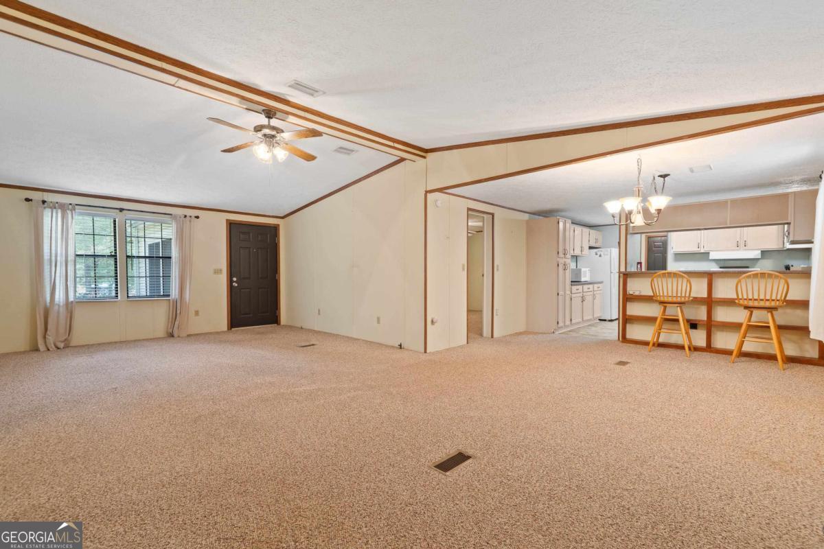 180 De Jarnette Road Southeast Eatonton, GA 31024 - Photo 16 of 66 a view of an empty room with a window