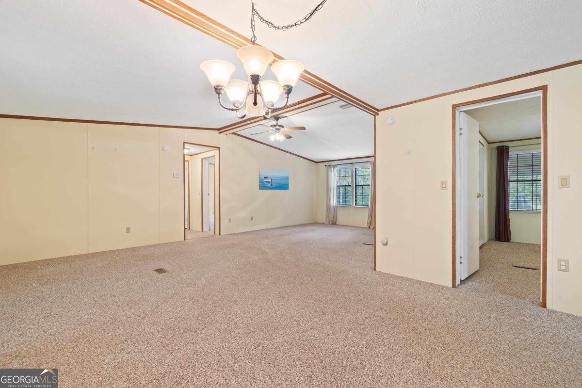 180 De Jarnette Road Southeast Eatonton, GA 31024 - Photo 17 of 66 a view of a room with wooden floor and windows