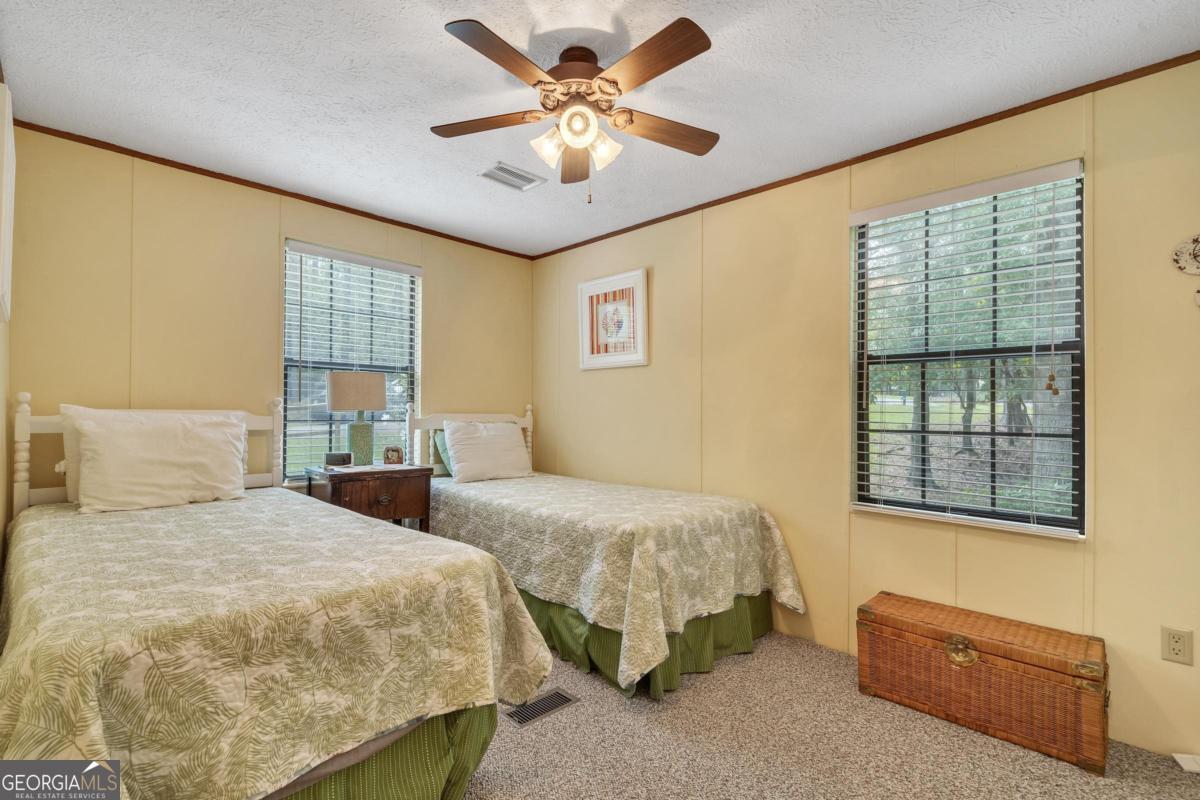 180 De Jarnette Road Southeast Eatonton, GA 31024 - Photo 30 of 66 a bedroom with double bed and a window