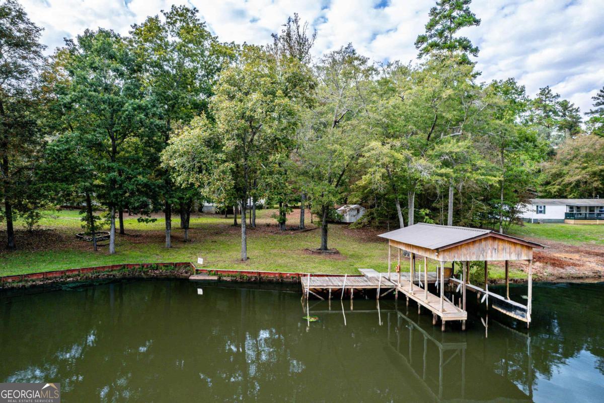 180 De Jarnette Road Southeast Eatonton, GA 31024 - Photo 3 of 66 a view of swimming pool with outdoor seating and lake