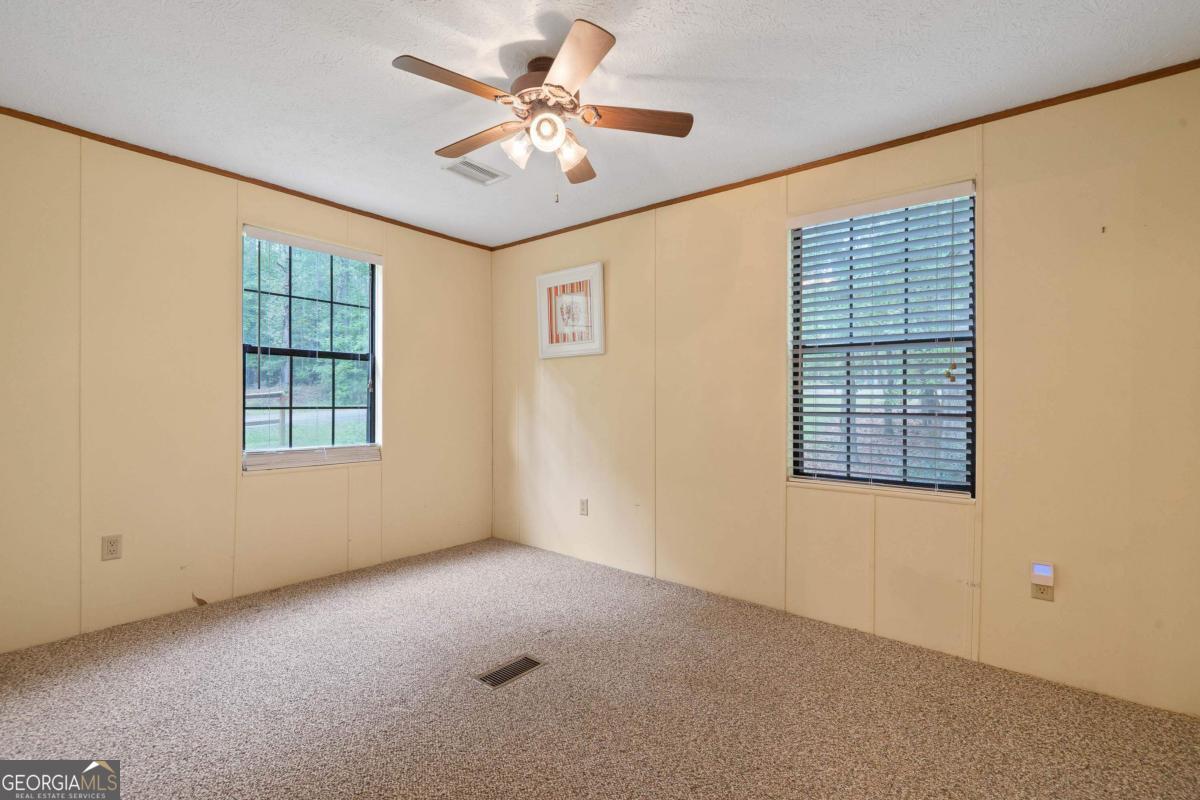 180 De Jarnette Road Southeast Eatonton, GA 31024 - Photo 31 of 66 a view of an empty room with a window