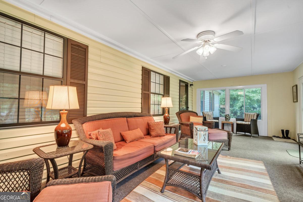 180 De Jarnette Road Southeast Eatonton, GA 31024 - Photo 33 of 66 a living room with furniture and a large window