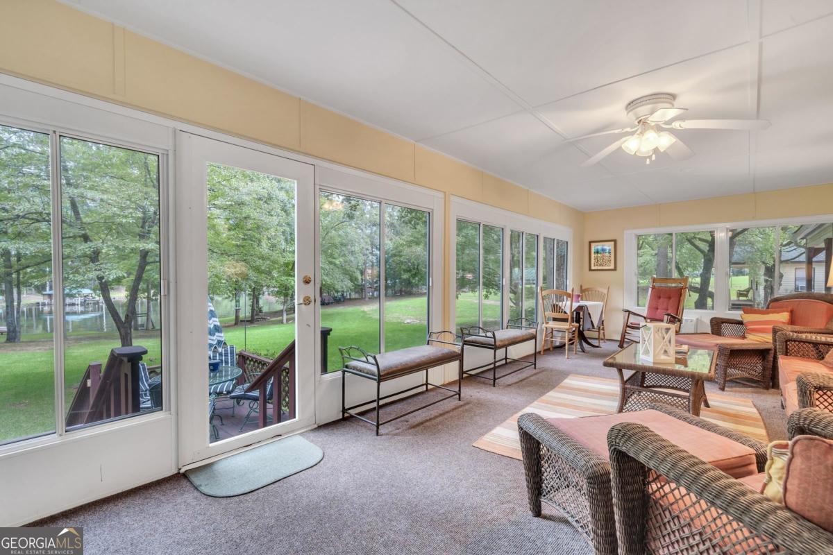 180 De Jarnette Road Southeast Eatonton, GA 31024 - Photo 34 of 66 a living room with furniture and a large window with balcony view