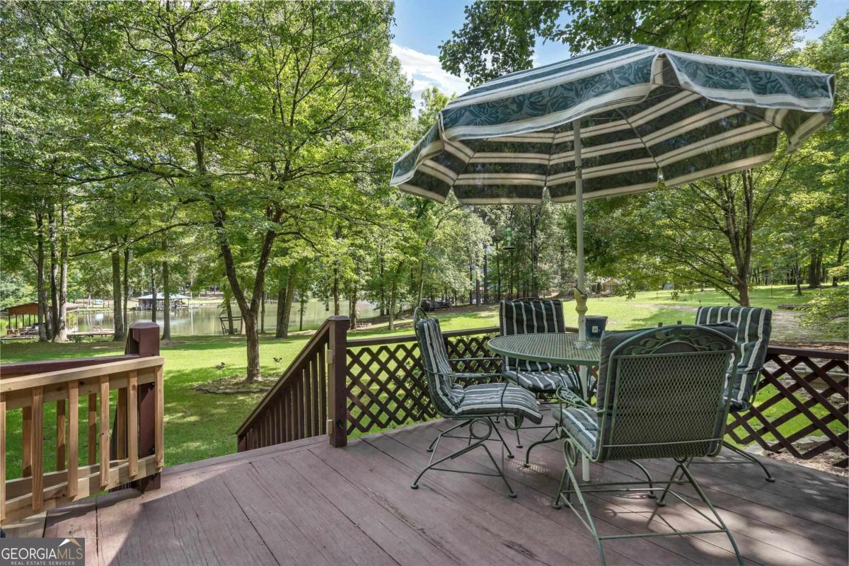180 De Jarnette Road Southeast Eatonton, GA 31024 - Photo 38 of 66 a view of balcony with chairs and wooden fence