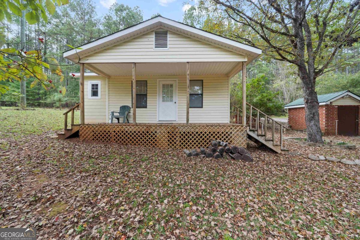 180 De Jarnette Road Southeast Eatonton, GA 31024 - Photo 39 of 66 a view of a house with a yard