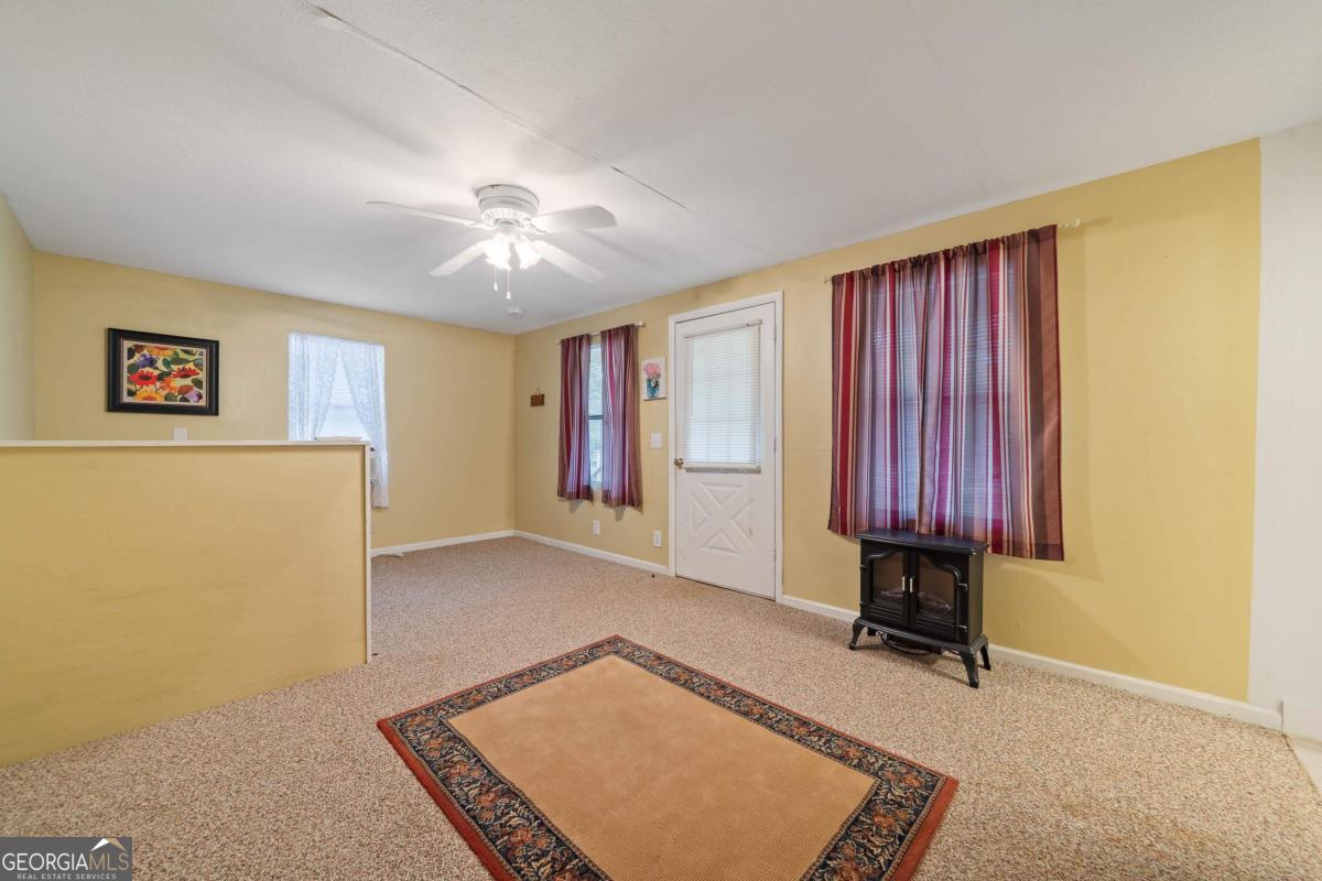 180 De Jarnette Road Southeast Eatonton, GA 31024 - Photo 44 of 66 a view of a room with furniture and a window