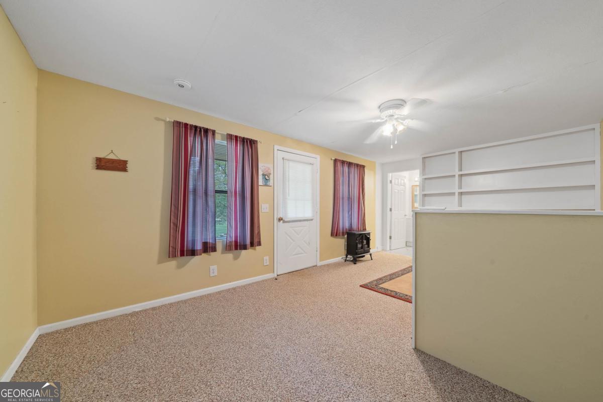 180 De Jarnette Road Southeast Eatonton, GA 31024 - Photo 45 of 66 a view of a room with a furniture and a ceiling fan