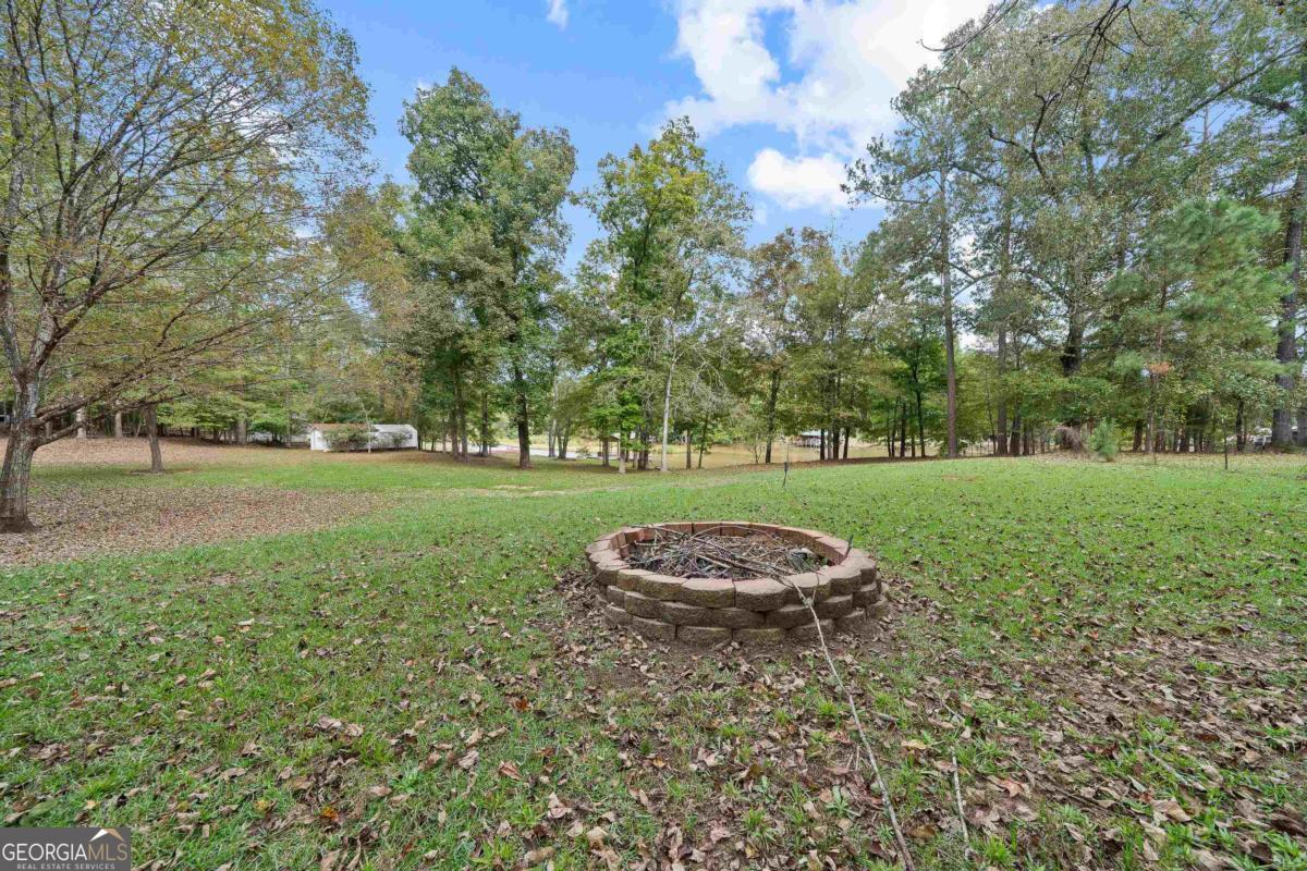 180 De Jarnette Road Southeast Eatonton, GA 31024 - Photo 49 of 66 a view of a golf course with a garden