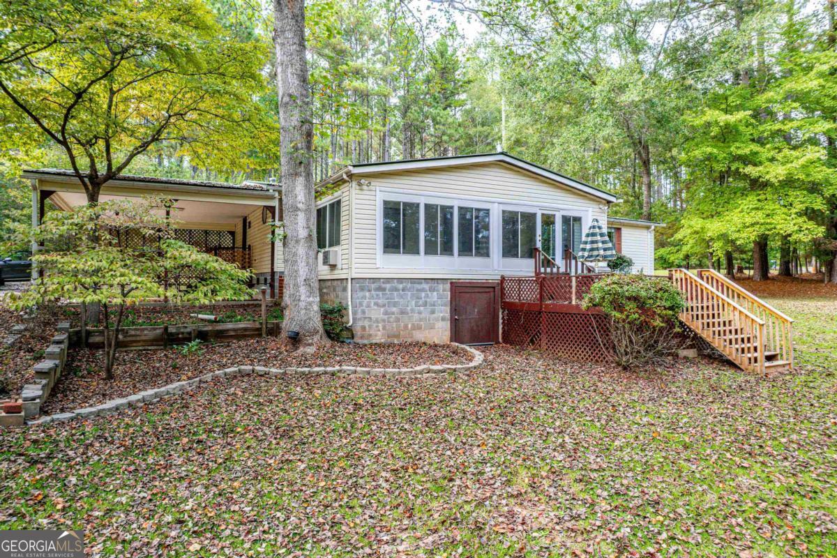 180 De Jarnette Road Southeast Eatonton, GA 31024 - Photo 59 of 66 a view of a house with a yard