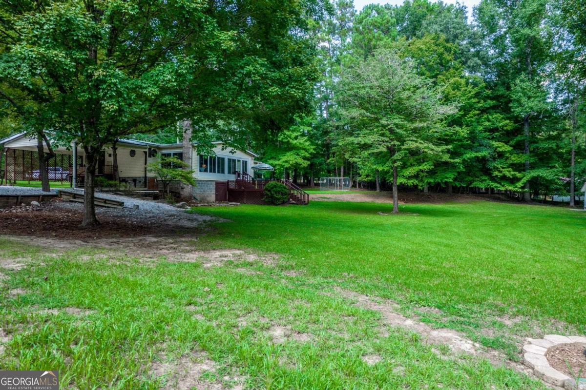 180 De Jarnette Road Southeast Eatonton, GA 31024 - Photo 60 of 66 a view of a house with a yard
