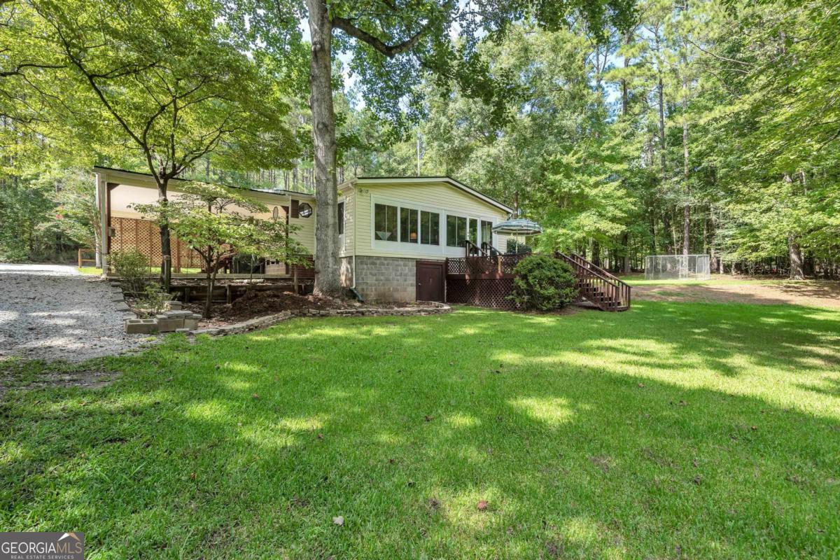 180 De Jarnette Road Southeast Eatonton, GA 31024 - Photo 64 of 66 a front view of a house with garden