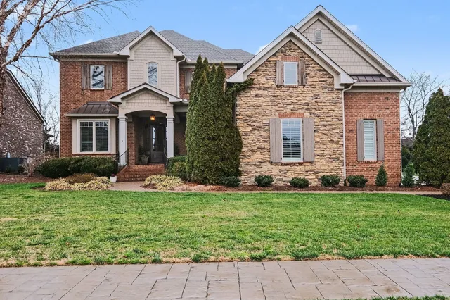 a front view of a house with a yard