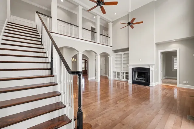 a view of a livingroom with wooden floor and a fireplace