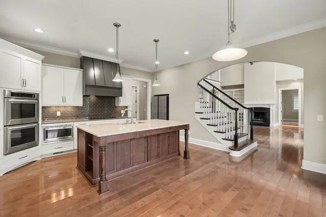 a kitchen with stainless steel appliances a stove a sink and a refrigerator