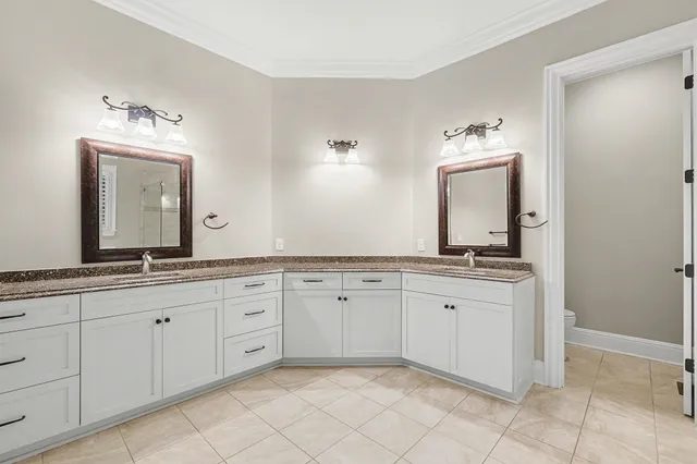 a spacious bathroom with a granite countertop sink and a mirror