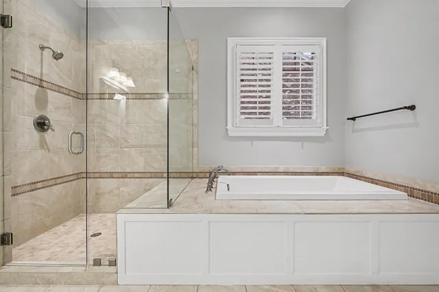 a bathroom with a bathtub and shower