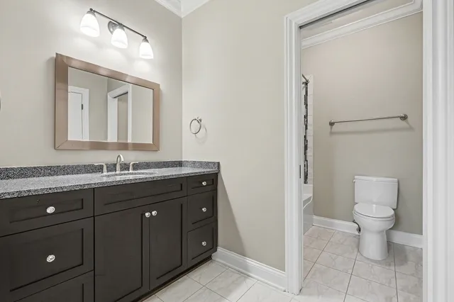 a bathroom with a toilet a sink and mirror