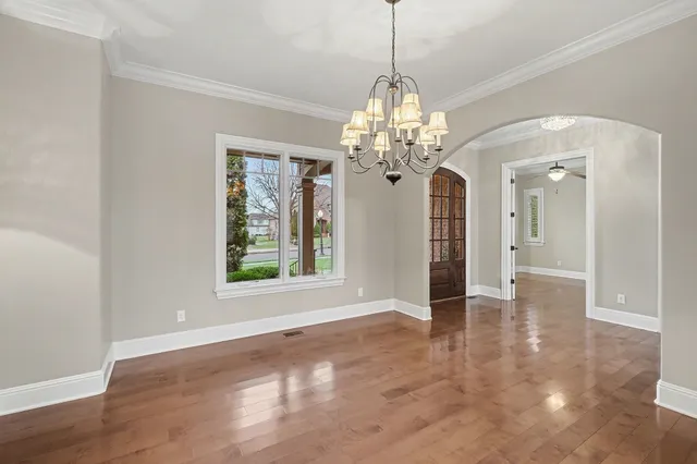 a view of a chandelier in big room and chandelier