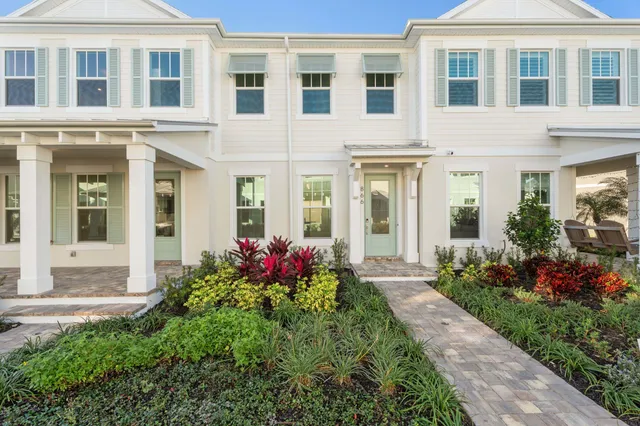 front view of a brick house with a yard