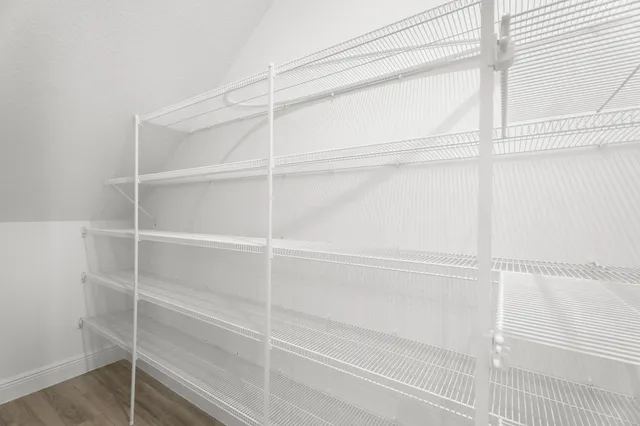 a view of walk in closet with empty racks
