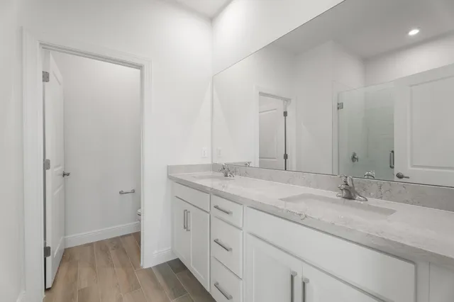 a bathroom with a granite countertop sink two mirror and a