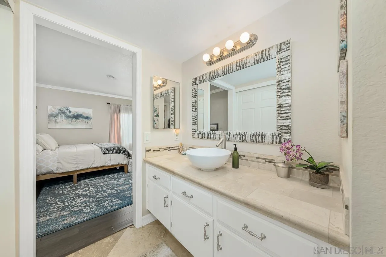 865 Buttercup Road Carlsbad, CA 92011 - Photo 17 of 30 a bathroom with a double vanity sink mirror and bathtub