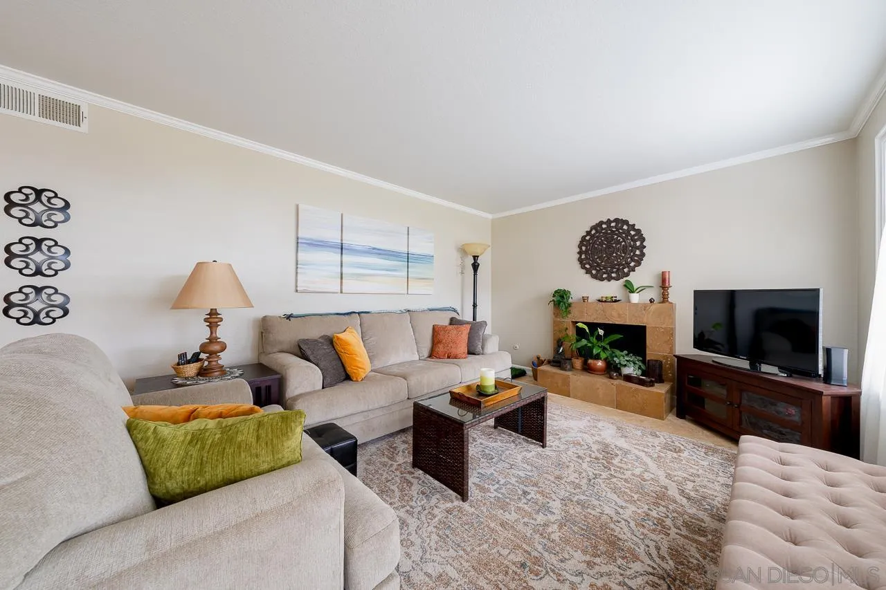 865 Buttercup Road Carlsbad, CA 92011 - Photo 3 of 30 a living room with furniture and a flat screen tv