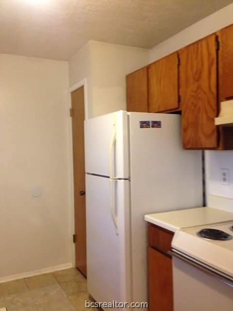 a white refrigerator freezer sitting inside of a kitchen