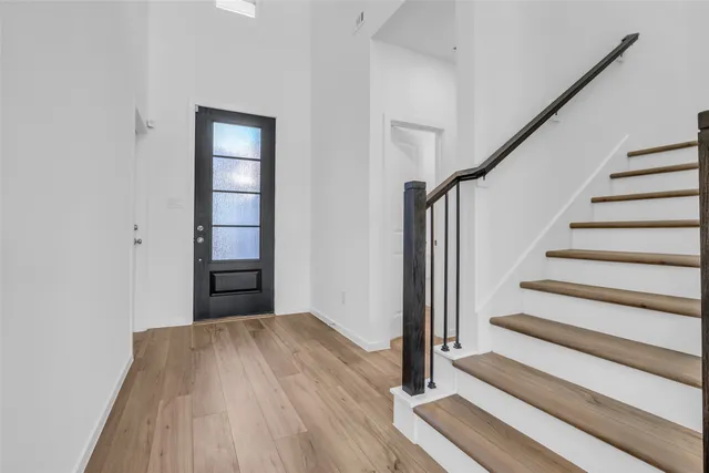 a view of a room with wooden floor and stairs